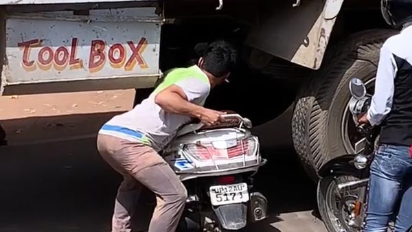 young-man-takes-scooter-under-truck-video-goes-viral-details